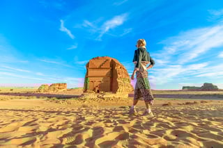 blonde Tourist Walking In The Desert Admiring The Monumental Qasr Al Farid A Solitary Nabatae