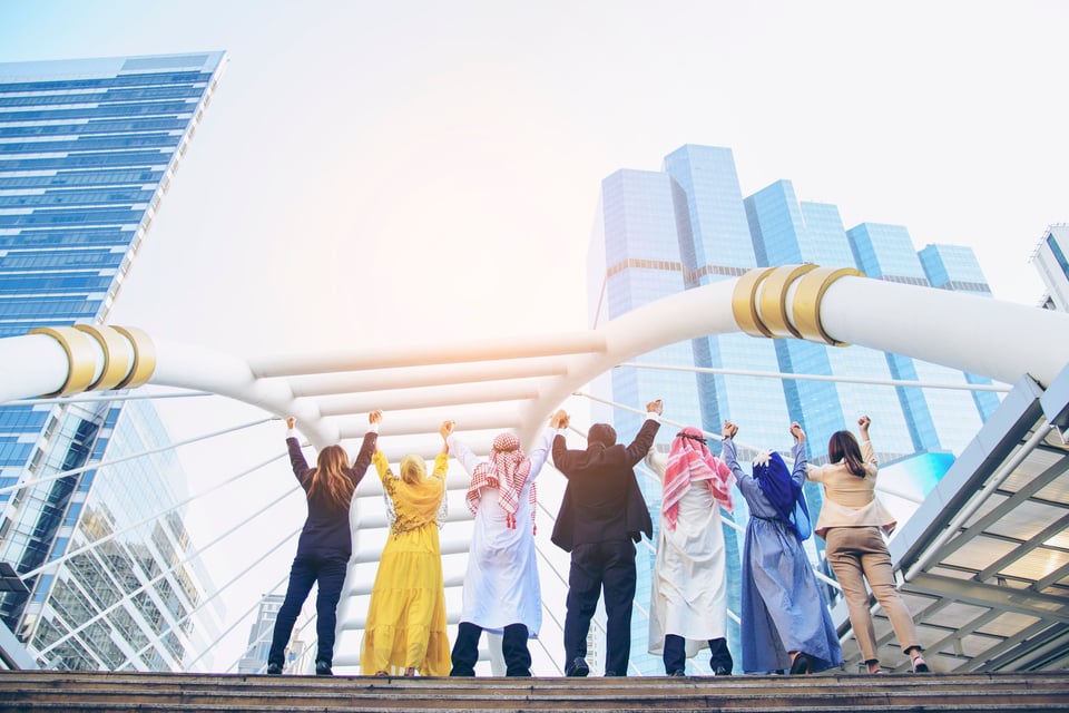 Businessmen And Women Raise Their Hands In Celebration