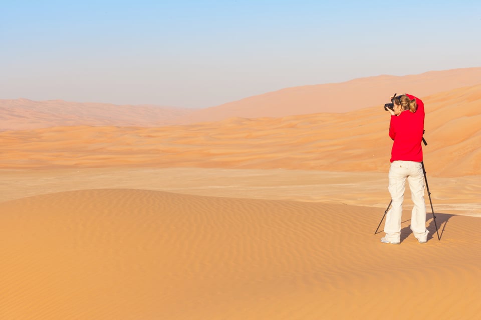 Woman Photographing Sand Dunes In The Rub Al Khali Or Empty Quarter Straddling Oman Saudi Arabia